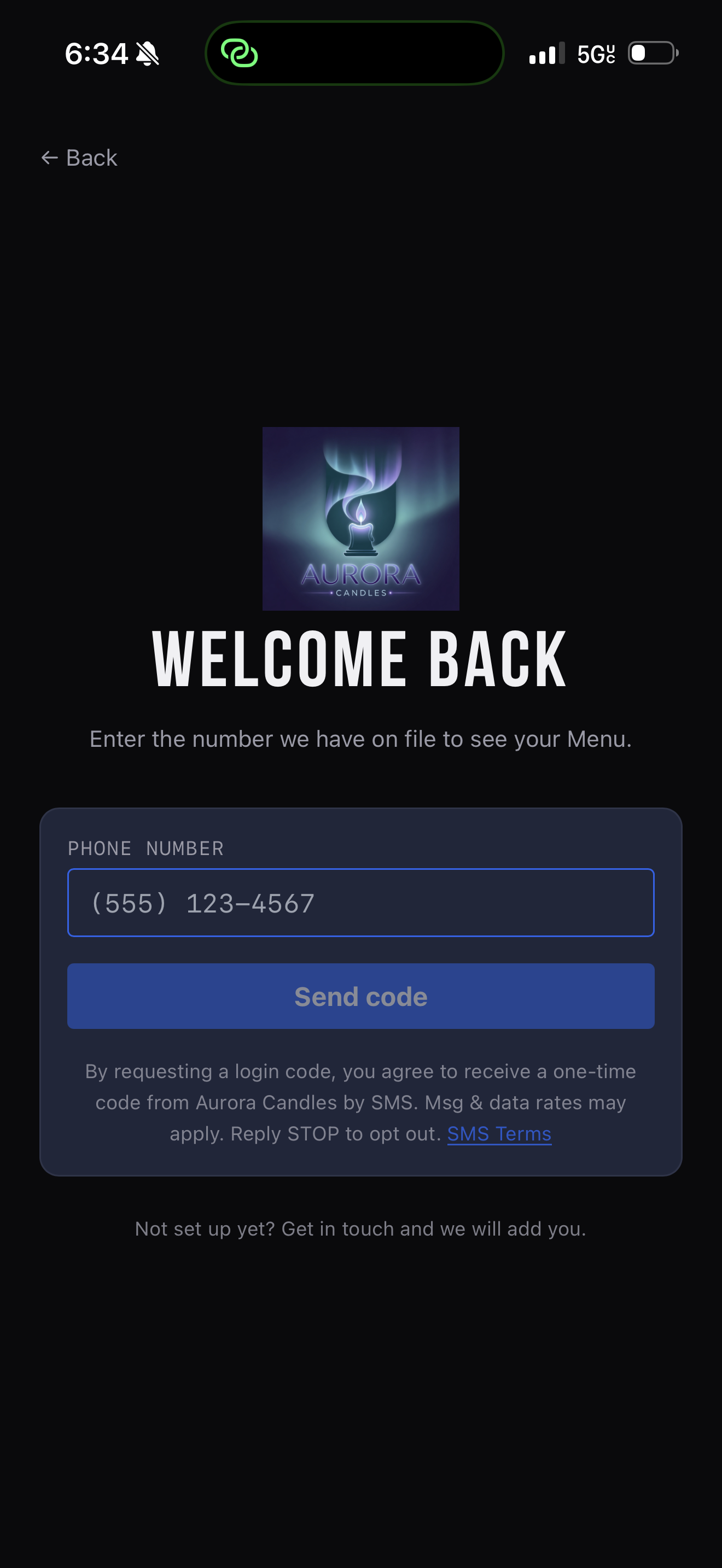 Store sign-in screen showing the phone-number field, Send code button, and SMS consent line.